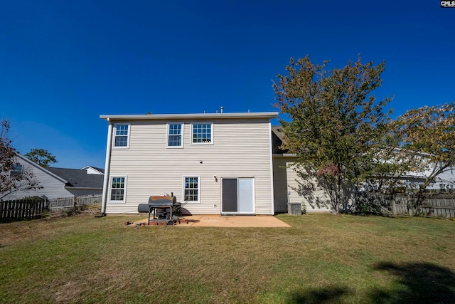 rear view of property featuring a yard and a patio area