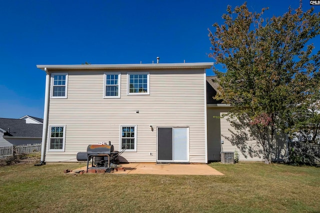 rear view of house featuring a patio area and a lawn