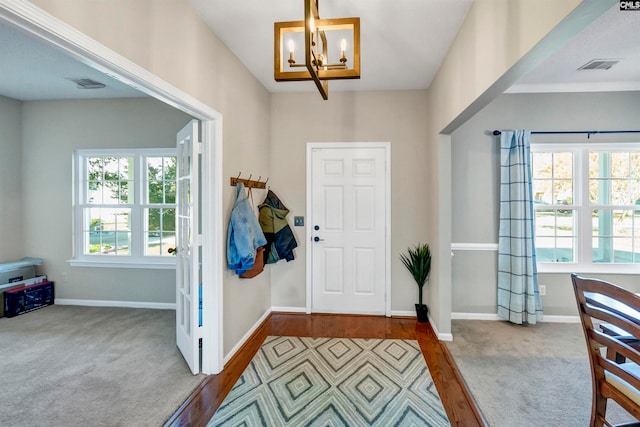 entryway featuring a chandelier and light hardwood / wood-style floors