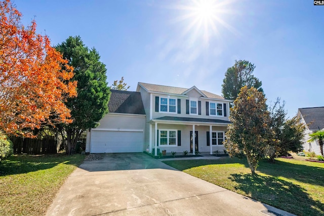 view of front of house with a porch, a front lawn, and a garage