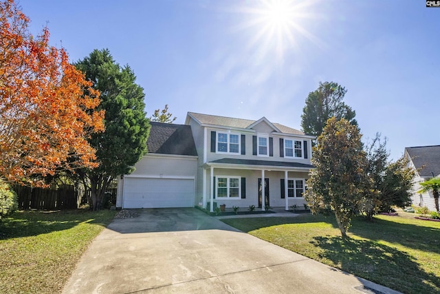 view of front of home featuring a porch, an attached garage, concrete driveway, and a front lawn