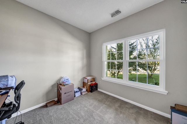 unfurnished office featuring visible vents, carpet flooring, and baseboards