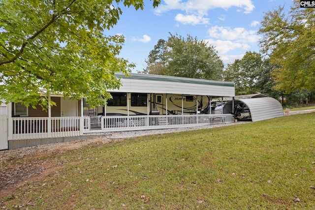 view of vehicle parking featuring a yard and a carport