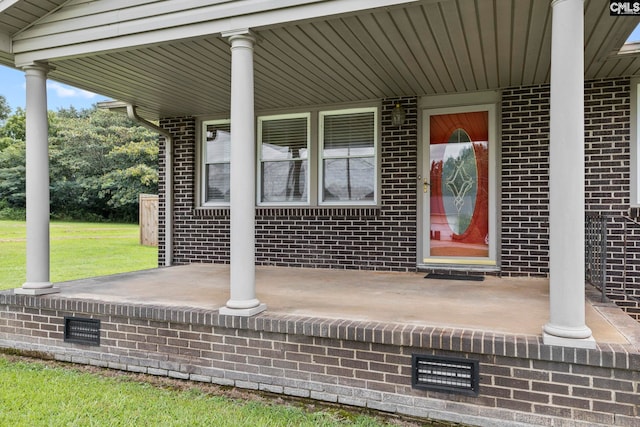 view of exterior entry featuring a yard