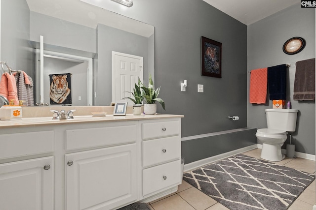 bathroom featuring toilet, vanity, and tile patterned floors