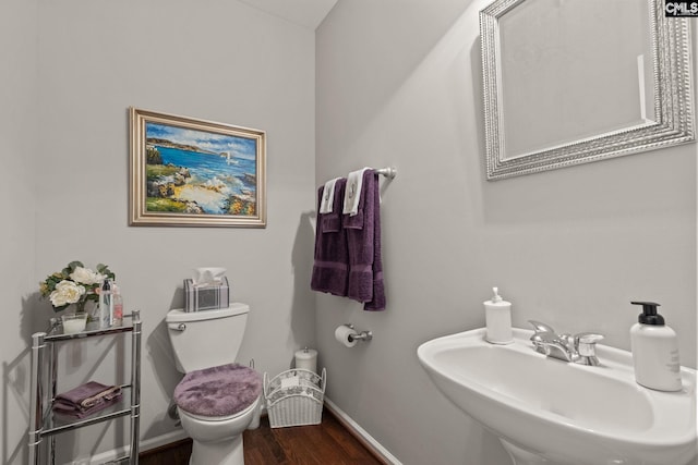 bathroom with sink, hardwood / wood-style flooring, and toilet