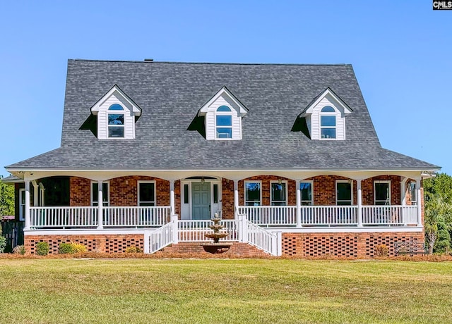 view of front of house with a front yard and a porch