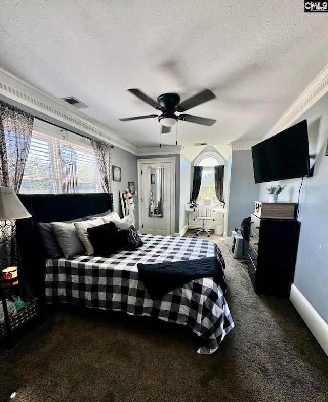 bedroom featuring crown molding, carpet flooring, a textured ceiling, and ceiling fan