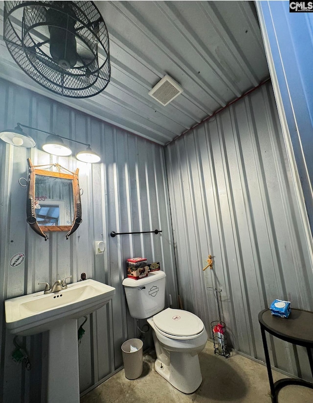 bathroom featuring toilet and concrete floors