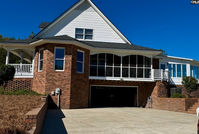 view of front of property with a garage and a sunroom