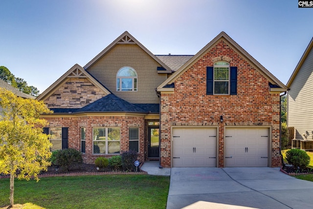 view of front of house featuring a front lawn and a garage