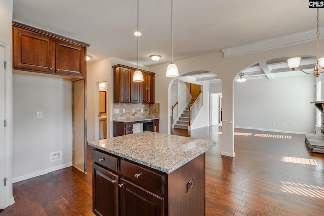 kitchen with tasteful backsplash, a center island, dark hardwood / wood-style floors, and hanging light fixtures