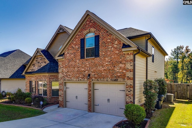 view of front property with central AC, a front lawn, and a garage