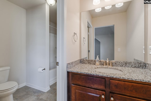 bathroom with vanity, toilet, and a shower