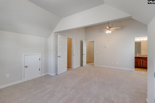 interior space featuring light carpet, lofted ceiling, and ceiling fan