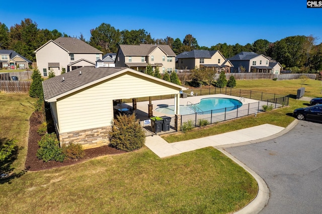 view of swimming pool featuring a patio area and a lawn