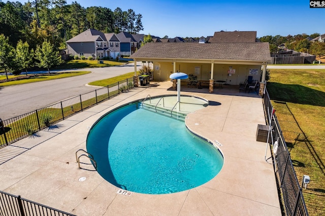 view of pool with a yard and a patio