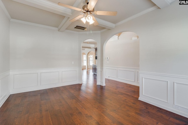 spare room featuring crown molding, beam ceiling, dark hardwood / wood-style floors, and ceiling fan