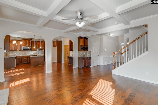 unfurnished living room with beam ceiling, sink, dark wood-type flooring, and coffered ceiling