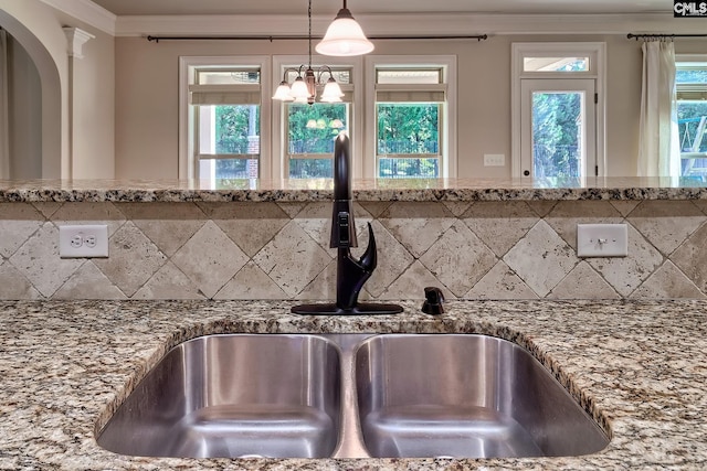 details featuring sink, stone countertops, and a chandelier