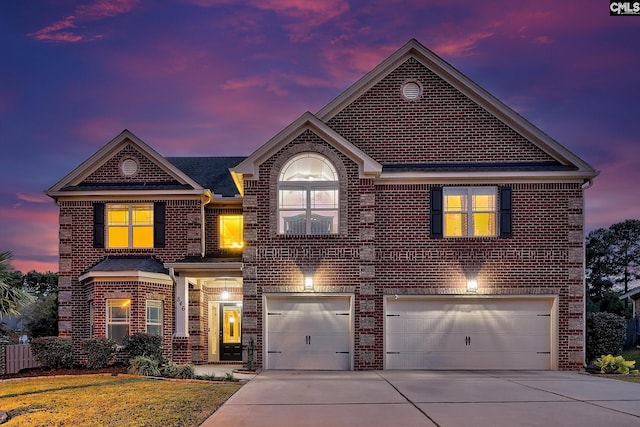 front facade featuring a lawn and a garage