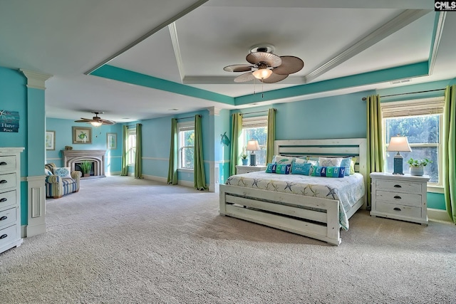 carpeted bedroom featuring multiple windows, crown molding, and ceiling fan