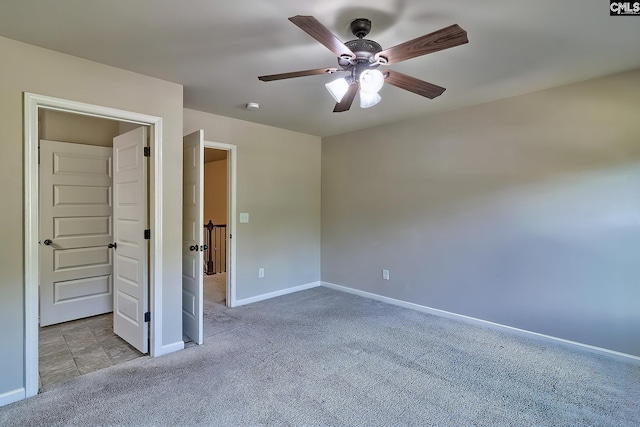 unfurnished bedroom featuring light colored carpet and ceiling fan