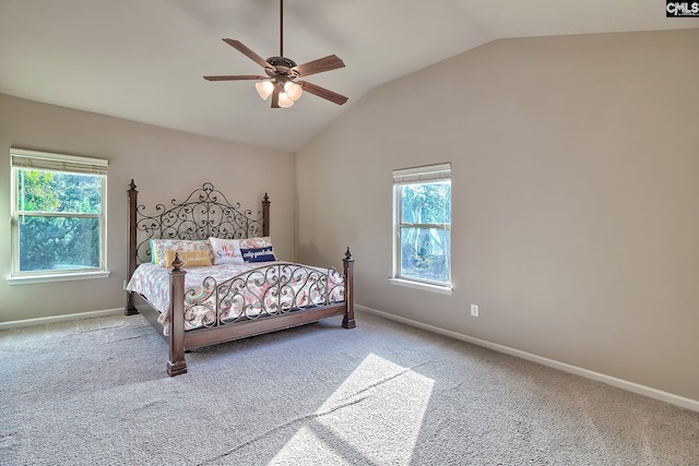 carpeted bedroom with vaulted ceiling, multiple windows, and ceiling fan