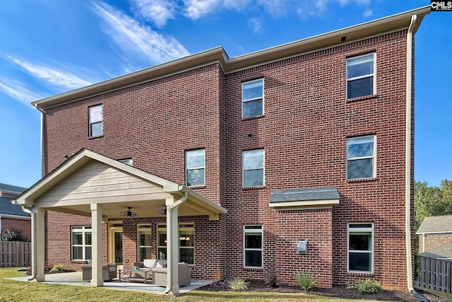 rear view of property with a patio and ceiling fan