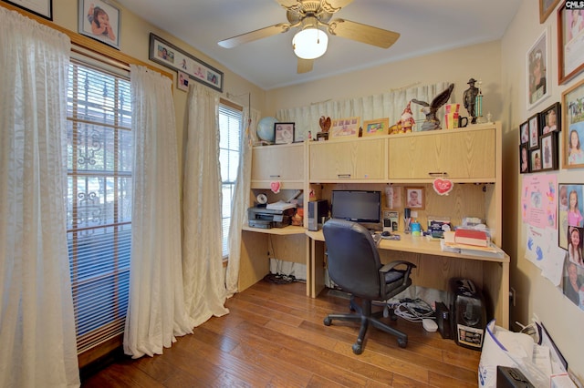 office area with built in desk, hardwood / wood-style flooring, and ceiling fan