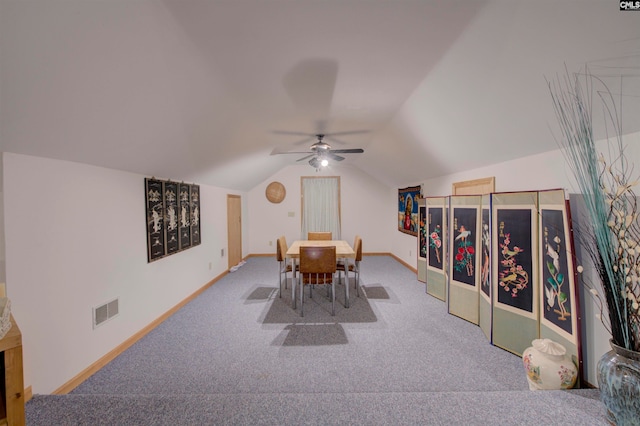 carpeted dining room featuring ceiling fan and lofted ceiling