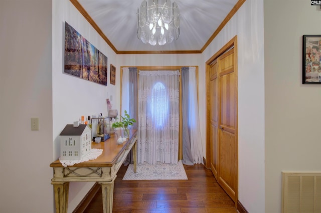 entrance foyer featuring crown molding, an inviting chandelier, and dark hardwood / wood-style floors