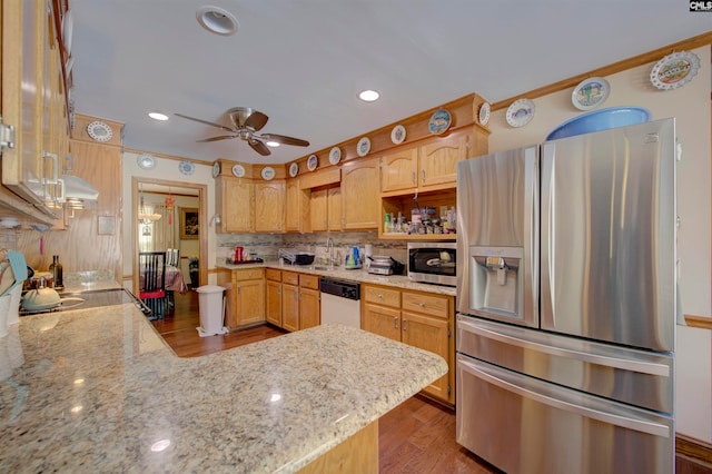 kitchen with appliances with stainless steel finishes, light stone counters, light hardwood / wood-style floors, and ceiling fan