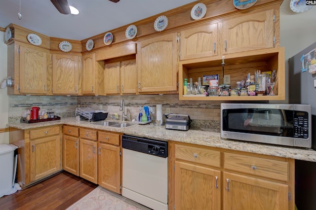 kitchen featuring sink, white dishwasher, ceiling fan, decorative backsplash, and dark hardwood / wood-style floors