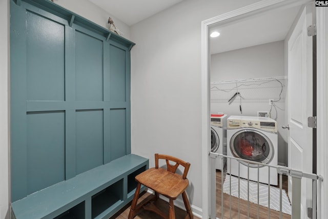 laundry room featuring dark wood-type flooring and washer and dryer