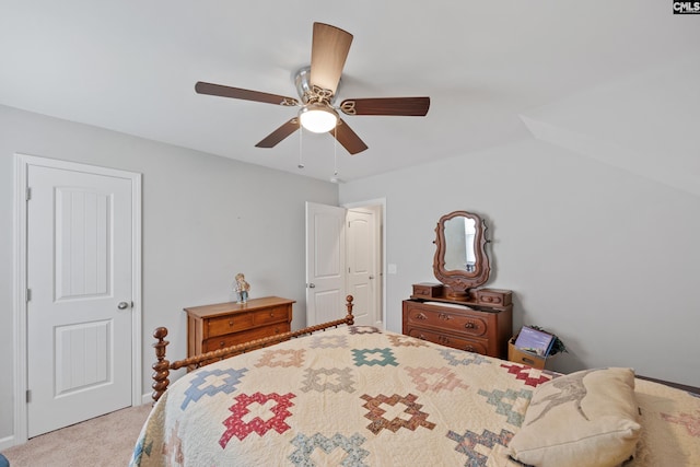 bedroom with ceiling fan, vaulted ceiling, and light colored carpet