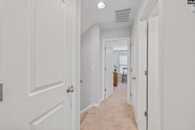 hallway featuring light carpet