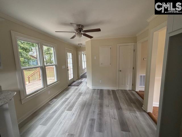 interior space featuring ornamental molding, hardwood / wood-style flooring, and ceiling fan