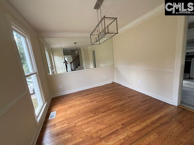 unfurnished dining area featuring wood-type flooring