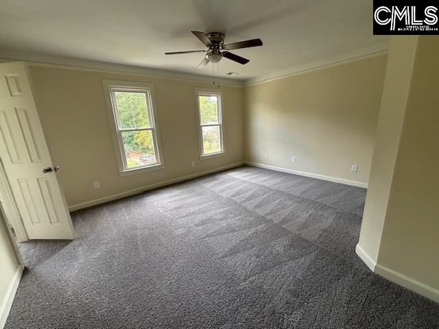 carpeted spare room featuring crown molding and ceiling fan