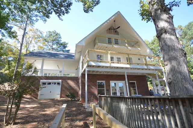 view of front of home featuring french doors, a garage, and a balcony