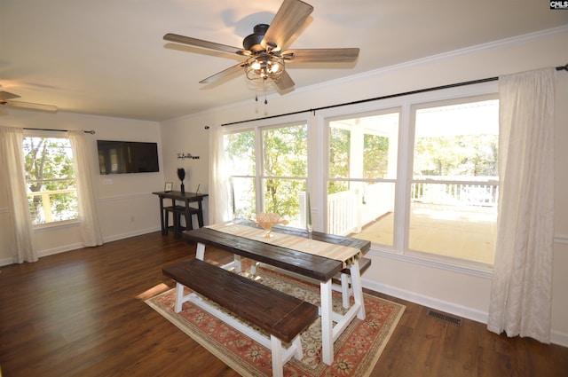 dining room featuring ornamental molding, dark wood-type flooring, and ceiling fan