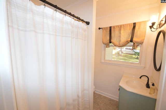 bathroom with vanity, toilet, and crown molding