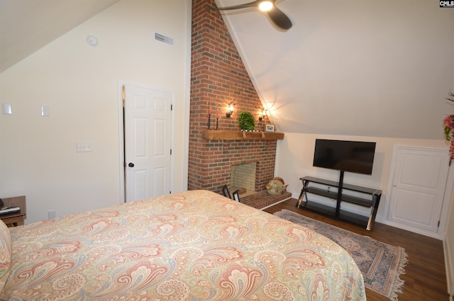 bedroom with lofted ceiling, wood-type flooring, a fireplace, and ceiling fan