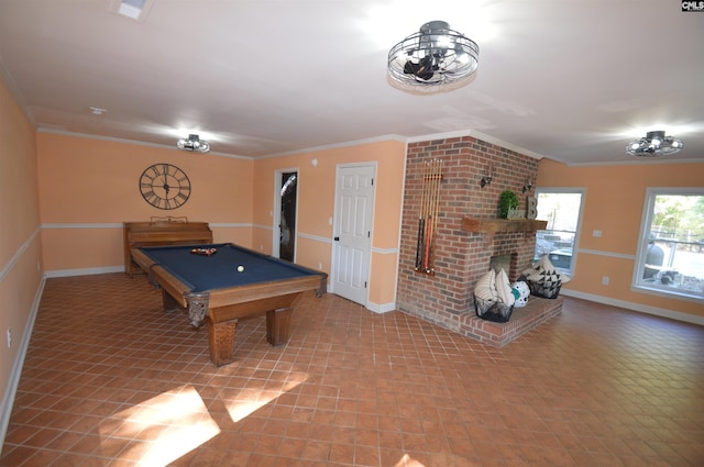 playroom featuring crown molding, pool table, and a fireplace