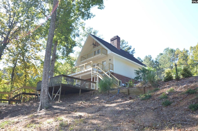 rear view of property with a wooden deck