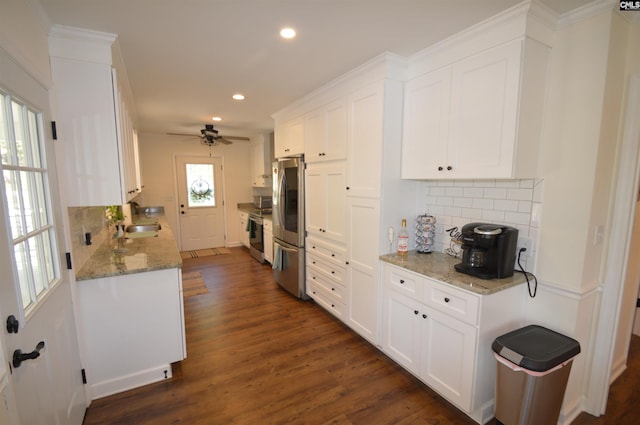 kitchen featuring white cabinetry, appliances with stainless steel finishes, plenty of natural light, and dark hardwood / wood-style floors