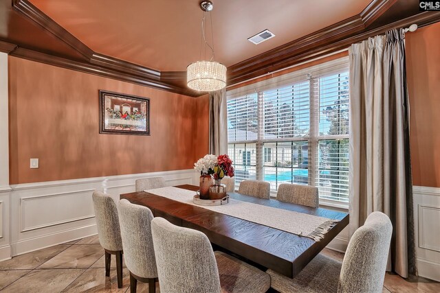 224 Robin Hood Rd, Elgin, SC 29045 - dining area with decorative columns, arched walkways, a chandelier, ornamental molding, and a decorative wall