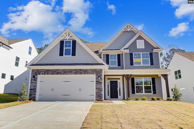 craftsman inspired home featuring a porch and a front lawn