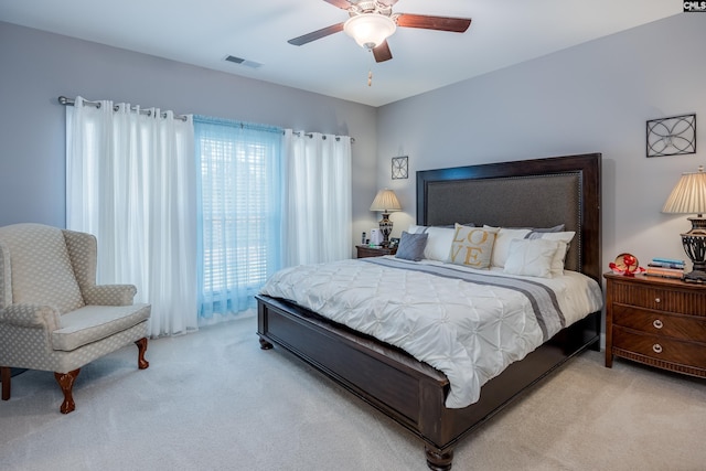 bedroom with light colored carpet and ceiling fan